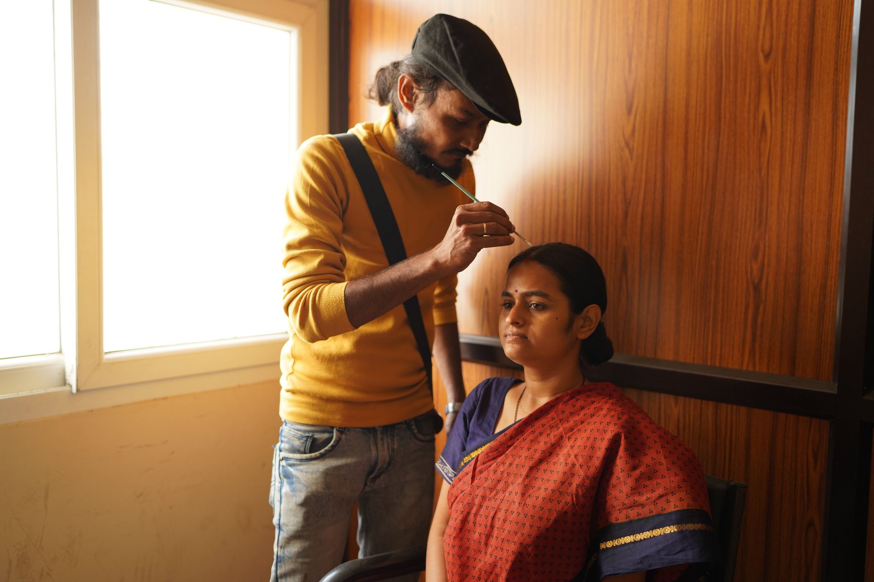 Makeup artist Sagar Singh preparing lead actress